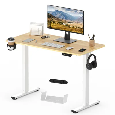 A standing desk with a computer monitor, keyboard, mouse, and accessories.
