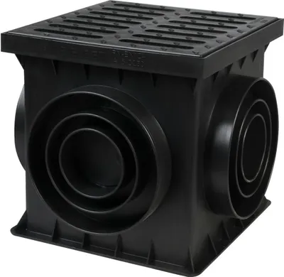 A black plastic drainage box with a grate on top and multiple circular inlets on the sides, shown against a white background.
