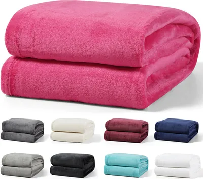 A stack of pink blankets on top, with smaller stacks of blankets in various colors below.