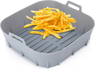 A gray silicone air fryer liner filled with french fries.