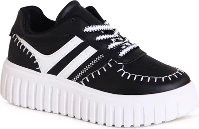 A studio shot of a single black and white platform sneaker.