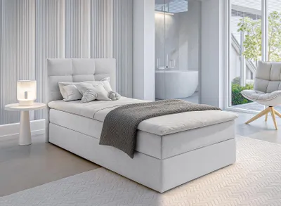 A modern bedroom with a single bed, a chair, and a bathtub visible in the background.