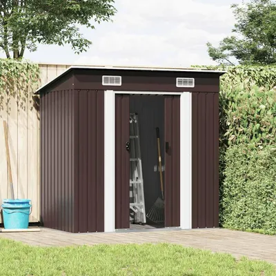 A brown metal garden shed with its doors open, showing a ladder and a rake inside. It is set up on a wooden deck in a backyard with grass and a wooden fence.