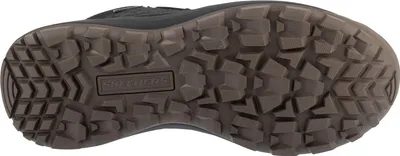 The sole of a black boot is shown from an underneath view.