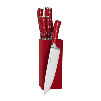 A set of red-handled kitchen knives in a red block.