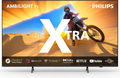 A television screen displaying a motocross rider in a desert landscape, with prominent text overlays and brand logos.