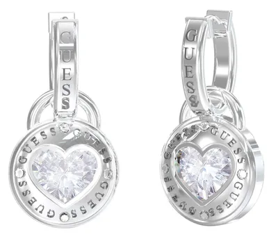 A pair of silver-toned Guess earrings with heart-shaped crystal pendants.