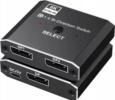 A close-up, slightly angled view of a black DisplayPort bi-directional switch with ports labeled DP1, DP2, and DC/5V.