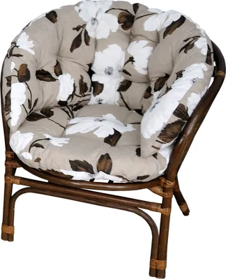A close-up studio shot of a floral patterned cushion on a rattan chair.