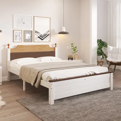 A bedroom scene with a bed, nightstand, and artwork on the wall.