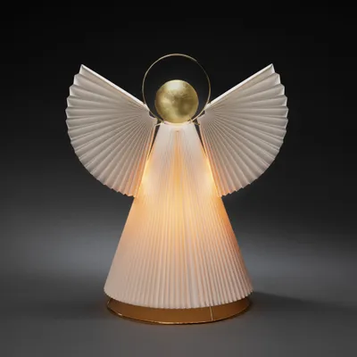 A white pleated angel decoration with a gold halo and orb, lit from within, against a dark gray background.