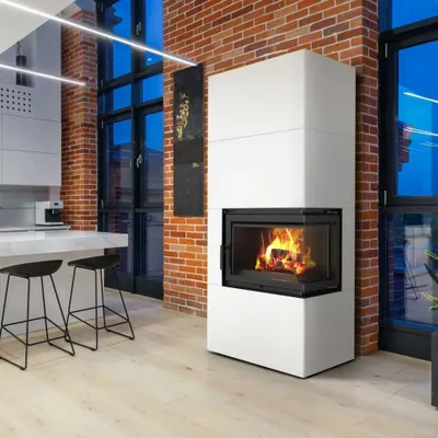 A modern living room with a fireplace and kitchen counter.