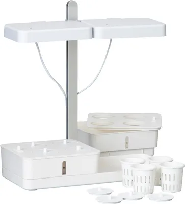 A white indoor gardening system with LED grow lights.