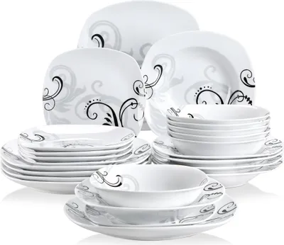 A set of white dinnerware with a black and gray swirl pattern is displayed against a white background.