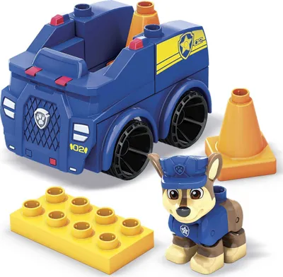 A toy police car and character from Paw Patrol, along with building blocks and traffic cones.