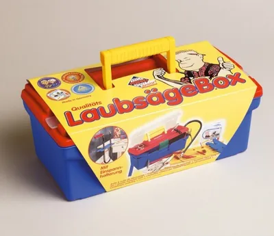 A toy toolbox with a saw and accessories, shown on a light gray background.