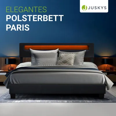 A modern bedroom setting with a bed as the focal point, illuminated by ambient lighting.