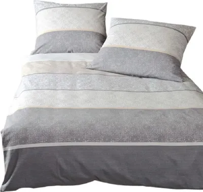 A neatly folded duvet cover and pillowcase set with a striped pattern in shades of gray, white, and sand.