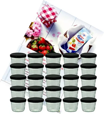 A set of small glass jars with black lids, along with ingredients for making jam, including strawberries, a packet of gelling sugar, and a checkered cloth.