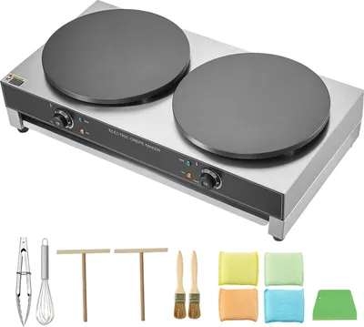 A double-headed electric crepe maker with various accessories displayed below it on a white background.