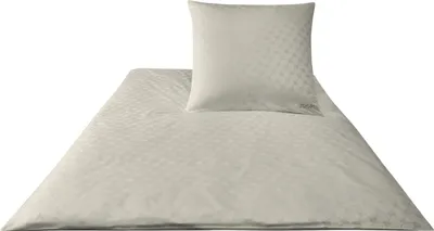 A white duvet cover and pillowcase with a subtle geometric pattern, laid out on a white background.