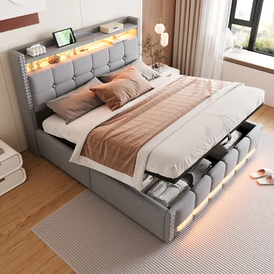 A modern bedroom with a grey upholstered bed frame featuring integrated LED lighting and storage compartments.