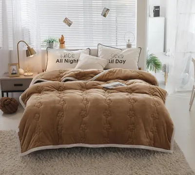 A bedroom scene with a bed made up with a brown comforter and pillows.