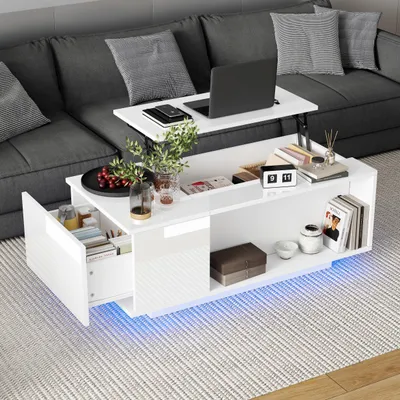 A modern white coffee table with a lifting top is placed in front of a sectional sofa.