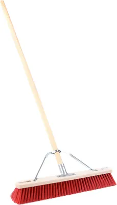 A broom with a wooden handle and red bristles, isolated on a white background.