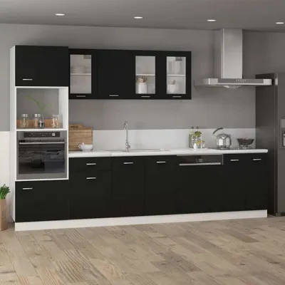A modern black and white kitchen with cabinets, a sink, and appliances.