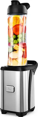 A personal blender with a clear container filled with fruits and vegetables, placed on its silver base.