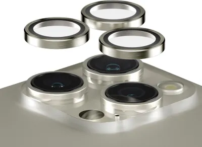 A close-up view of camera lens protectors being placed onto an iPhone.