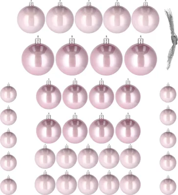 A collection of pink Christmas ornaments arranged in rows against a white background.