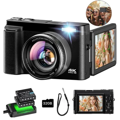 A black digital camera with accessories, including batteries, a charger, and a memory card, is displayed against a white background. The camera's screen is flipped out and shows a picture of a woman. A small inset image shows three people taking a selfie.