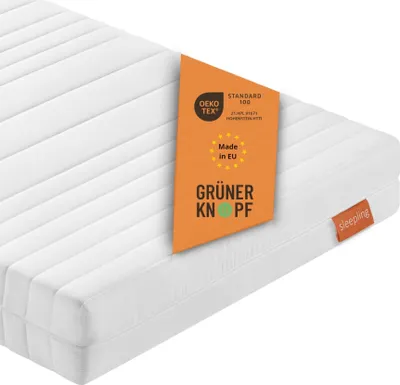 A white mattress with an orange tag showing certifications and origin information.