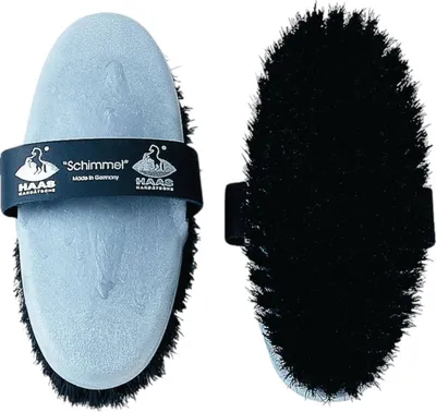 Two views of a horse grooming brush, one showing the handle and the other the bristles.