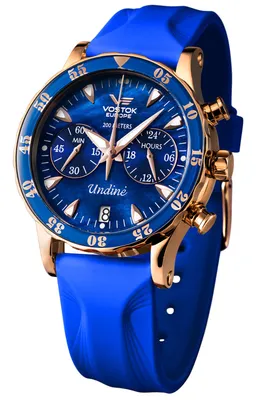 A close-up studio shot of a Vostok Europe watch with a blue dial and gold accents, presented on a white background.