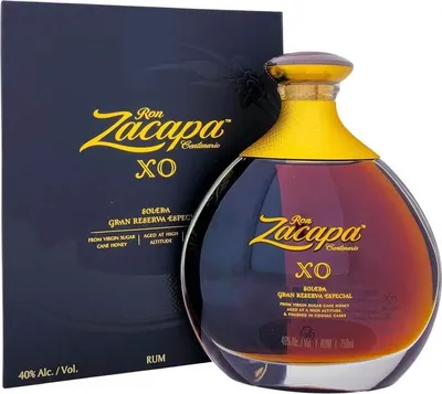 A bottle of Ron Zacapa XO Gran Reserva Especial rum and its accompanying box are displayed against a white background.