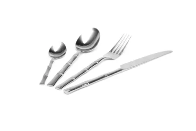 A set of four stainless steel cutlery pieces with a bamboo-like design on the handles, arranged diagonally on a white background.