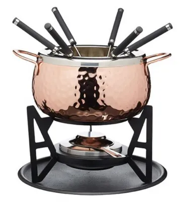 A copper fondue set with six black fondue forks, displayed on a black stand with a fuel burner.