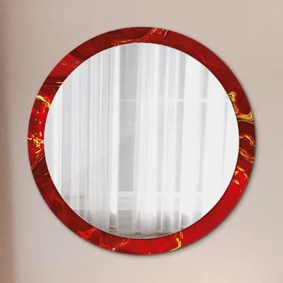 A round mirror with a red and gold marbled frame is mounted on a light gray wall, with white curtains visible in the reflection.