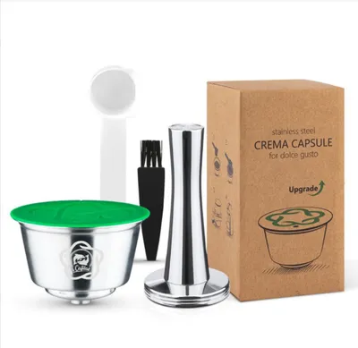 A set of reusable coffee capsules and accessories, including a tamper, scoop, and brush, displayed with their packaging.