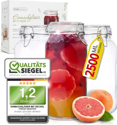 A set of three large glass jars, one filled with a red beverage and fruit slices, and two empty. A yellow tag indicates volume, and quality seals are displayed.