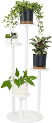 A white, multi-tiered plant stand displaying several potted plants.