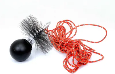A chimney brush with a rope attached, isolated on a white background.