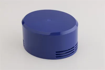 A blue cylindrical filter assembly with vents on the side and a flat top, set against a white background.