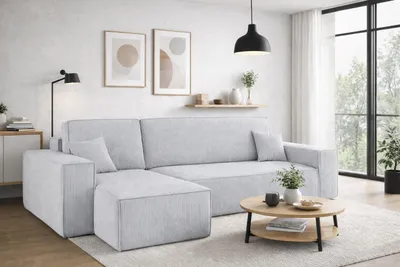 A modern living room with a sectional sofa, coffee table, and artwork.