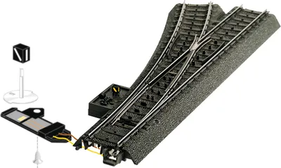A model railway turnout (switch) with associated accessories.
