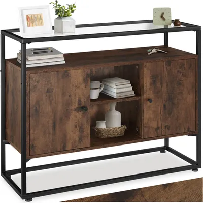 A sideboard with a rustic wood finish and black metal frame, displayed in a studio setting with decorative items on top.