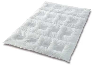 A white duvet is laid out flat on a white background, showing its quilted pattern.